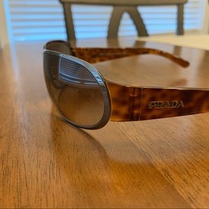 Prada sunglasses. Unisex.  Good condition but is missing left nose cushion